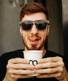 A guest in sunglasses holding a Loop cup